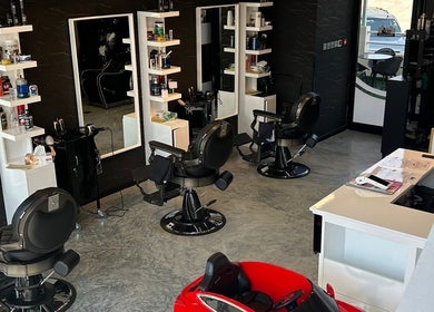 Modern barbershop at Hidd, Near In and Out Petrol Station, Al Hidd, Muḥāfaẓat Al-muḥarraq, BH with sleek chairs.