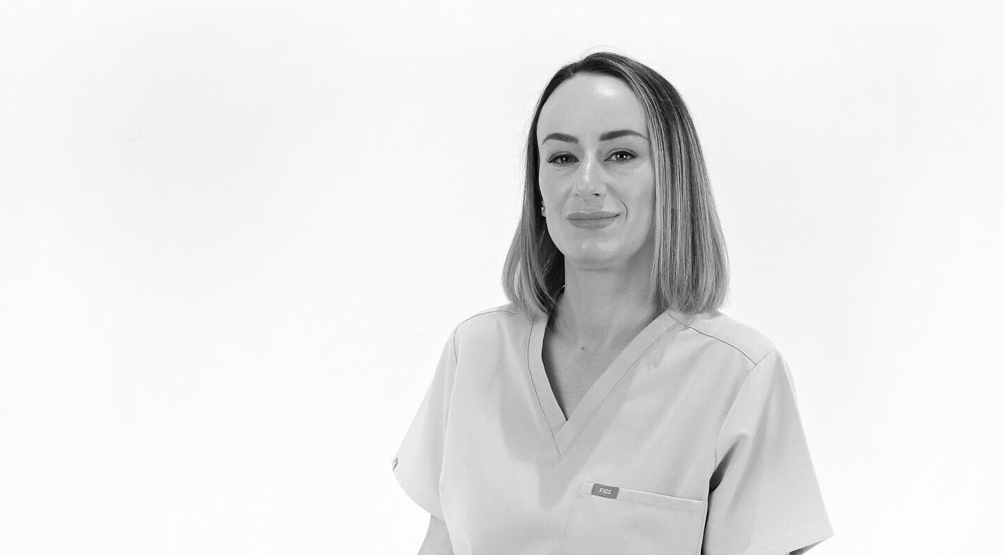 Professional therapist at Nura Skin, Dudley, England, GB, wearing a uniform, exemplifying skilled care.