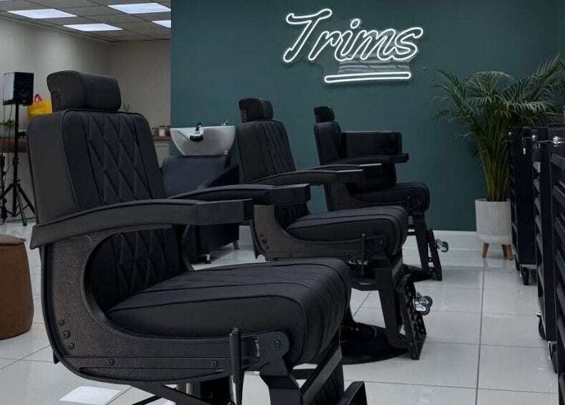 Modern barber chairs at Bez Barber, Birmingham, England, GB, offering a sleek and comfortable grooming experience.