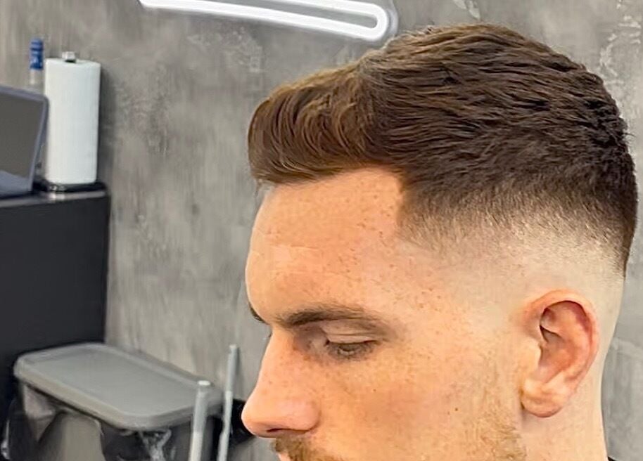Customer showcasing a sleek fade hairstyle at Bez Barber, Birmingham, England, GB.