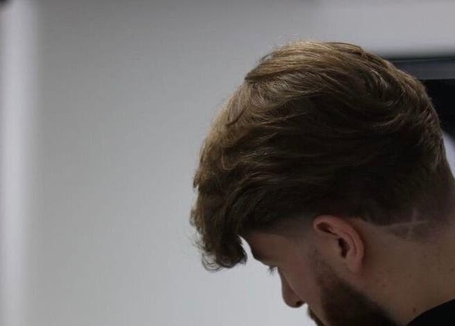 Stylish fade haircut with etched design at Bez Barber, Birmingham, England, GB.