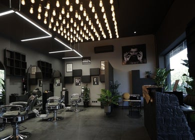 Modern interior of Cutz Hair Studio in Riyadh, SA, featuring sleek barber chairs and stylish decor.