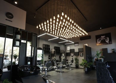 Chic interior of Cutz Hair Studio in Riyadh, SA, showcasing stylish decor and modern lighting.