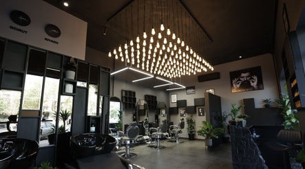 Chic interior of Cutz Hair Studio in Riyadh, SA, showcasing stylish decor and modern lighting.