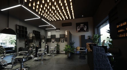 Modern interior of Cutz Hair Studio in Riyadh, SA, featuring stylish chairs and ambient lighting.