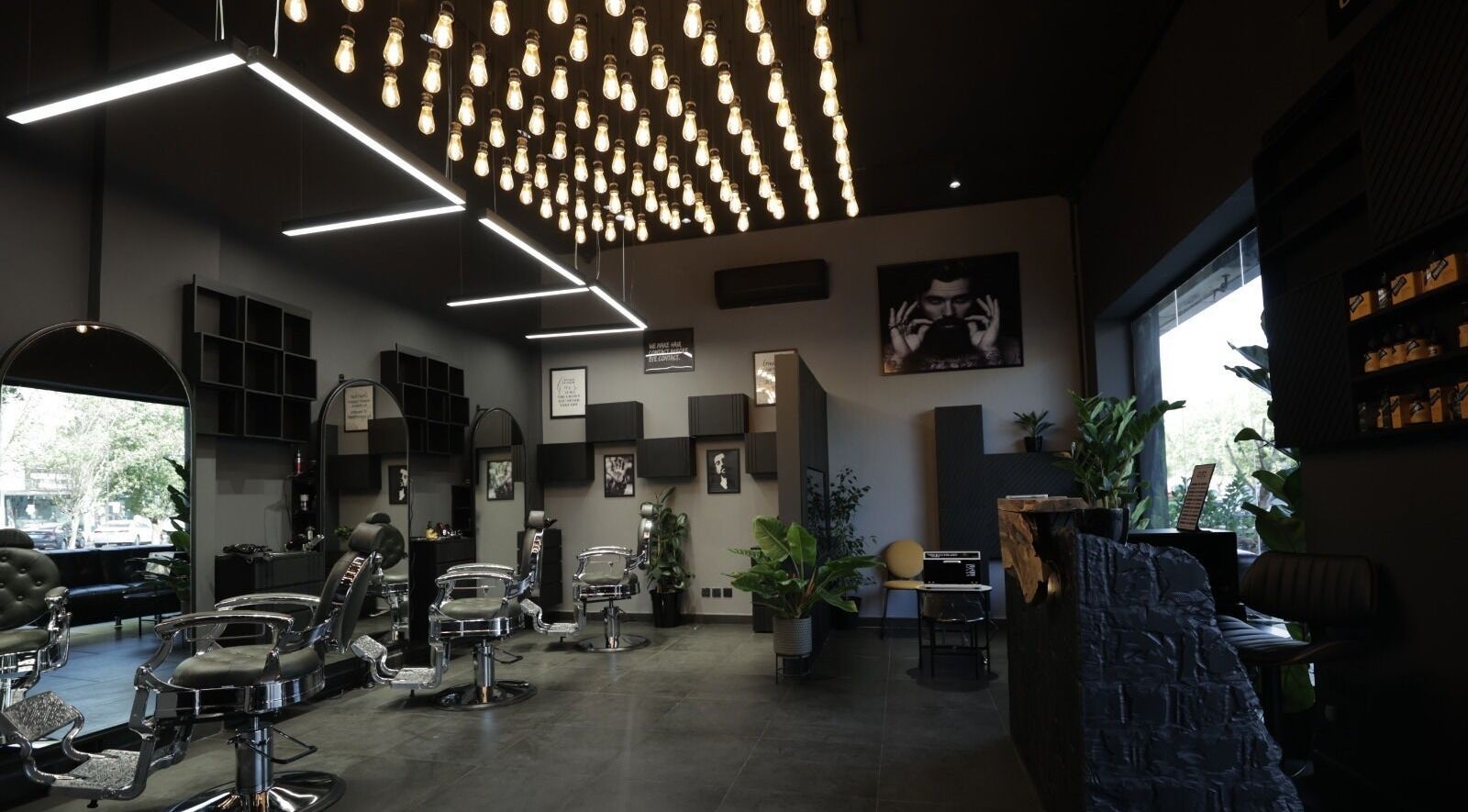 Modern interior of Cutz Hair Studio in Riyadh, SA, featuring stylish chairs and ambient lighting.