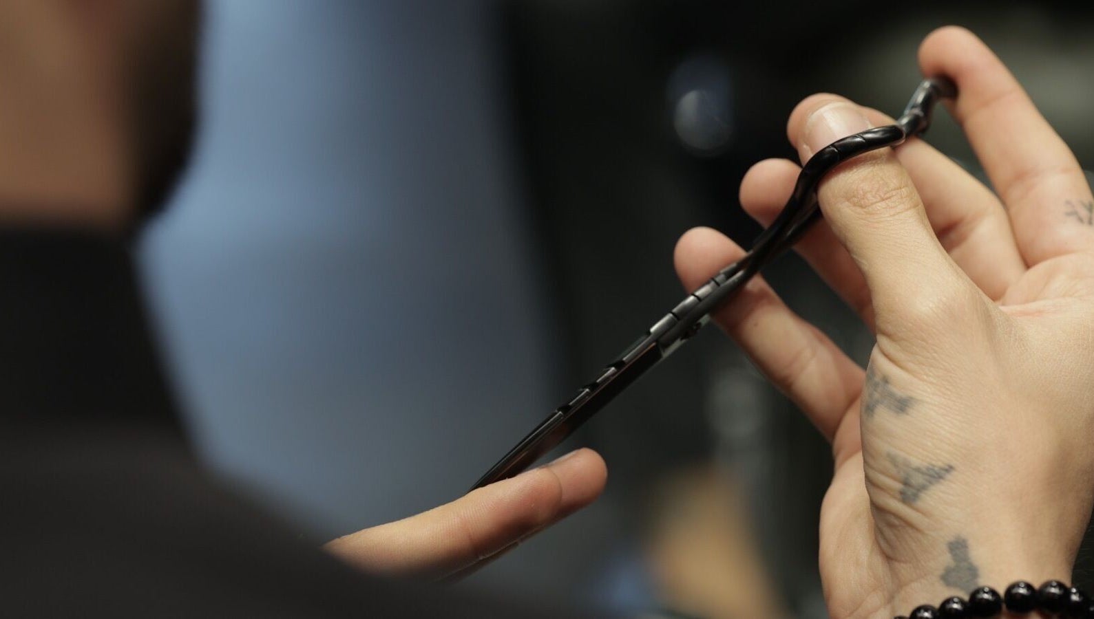Professional shears held by stylist at Cutz Hair Studio Premium, Riyadh, Riyadh Province, SA.