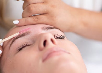 Eyebrow waxing at Glammed Up By E, Bradbury, New South Wales, AU. Close-up of client receiving precise care.