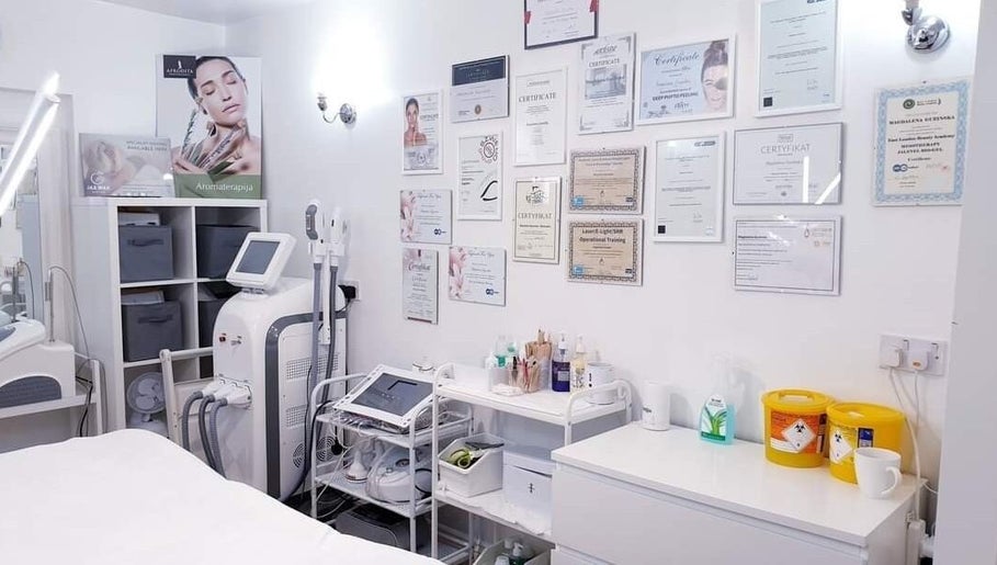 Bright treatment room at MG Institute of Beauty & Training Academy, Cheltenham, England, GB showcasing certifications.