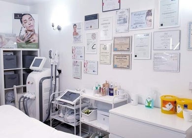 Bright treatment room at MG Institute of Beauty & Training Academy, Cheltenham, England, GB showcasing certifications.