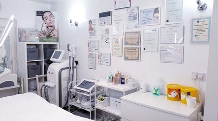 Bright treatment room at MG Institute of Beauty & Training Academy, Cheltenham, England, GB showcasing certifications.