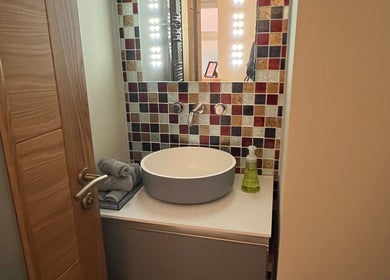 Modern bathroom sink at Humblebee Wellness in Saint Leonards, England, GB with stylish mosaic tiles.