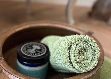 Rolled towel and skincare jar at Humblebee Wellness, Saint Leonards, England, GB, promoting relaxation.