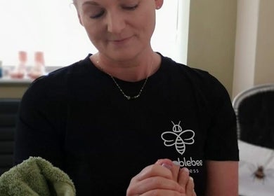 Professional at Humblebee Wellness in Saint Leonards, England, delivering a calming wellness treatment.