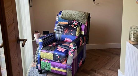 Colorful floral chair in cozy corner at Humblebee Wellness, Saint Leonards, England, GB.
