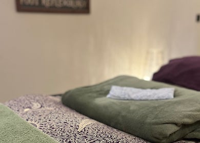 Cozy massage bed setup at Humblebee Wellness, Saint Leonards, England, GB, with plush towels and calming decor.
