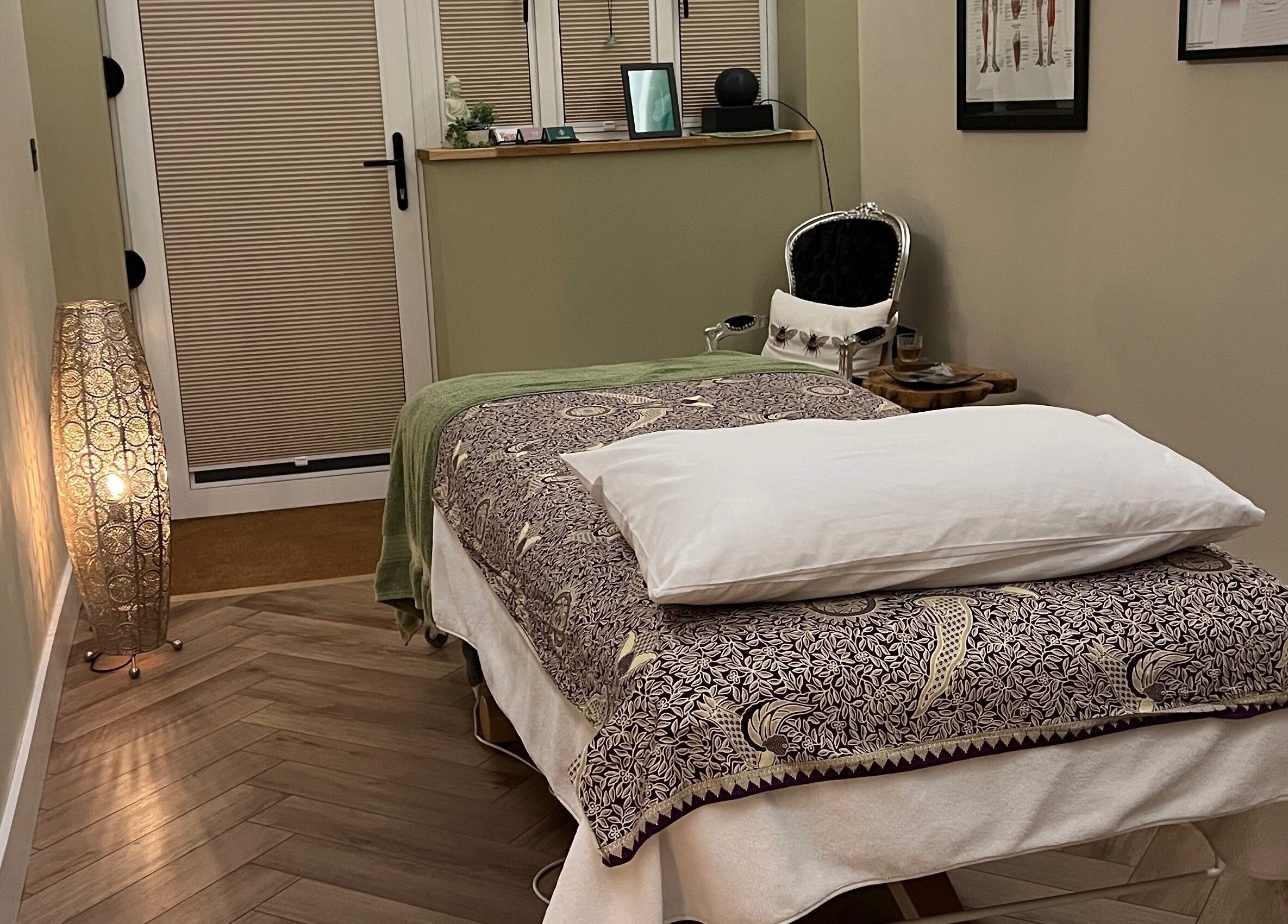 Massage room at Humblebee Wellness, Saint Leonards, England, GB, featuring a cozy treatment bed and ambient lighting.