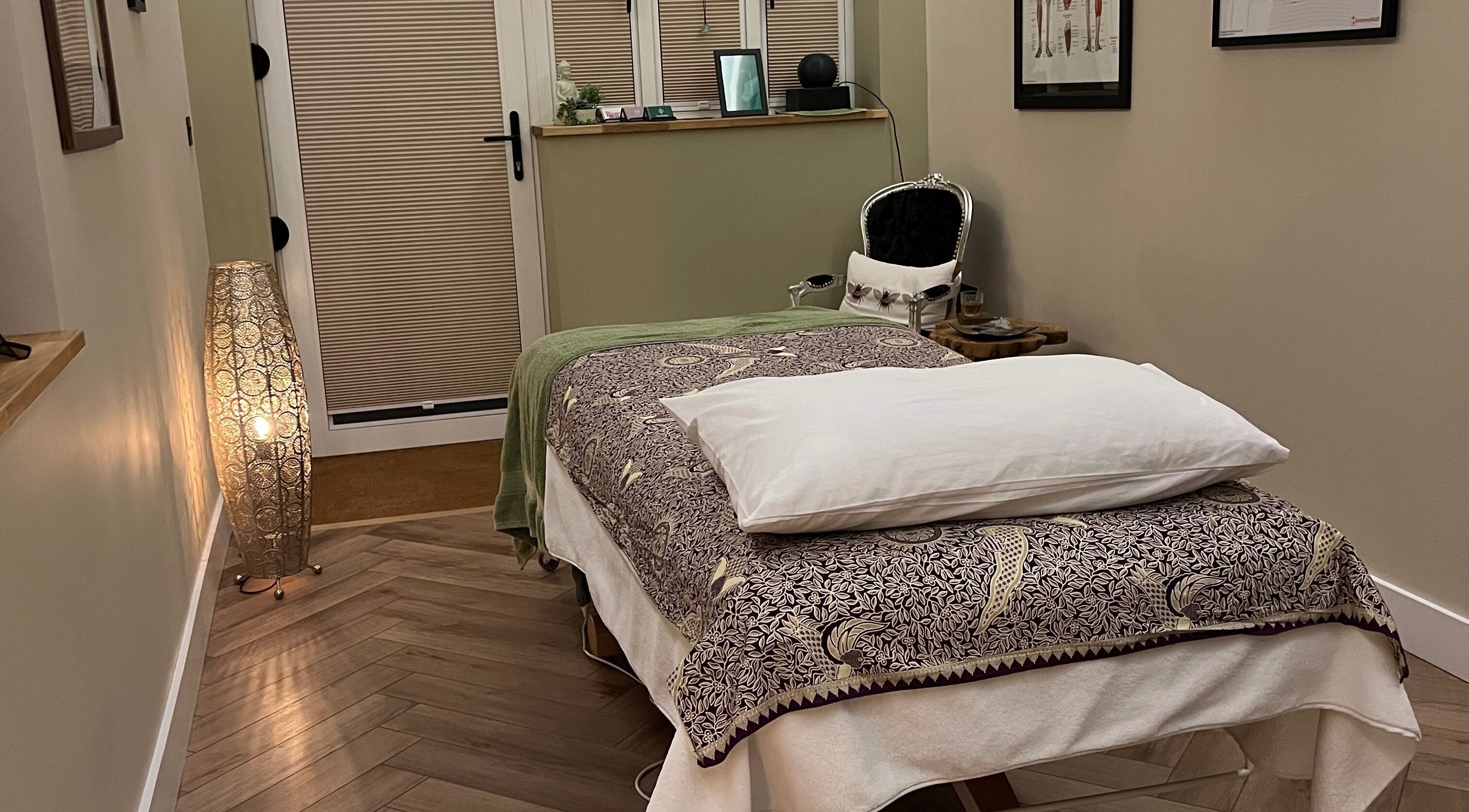 Massage room at Humblebee Wellness, Saint Leonards, England, GB, featuring a cozy treatment bed and ambient lighting.