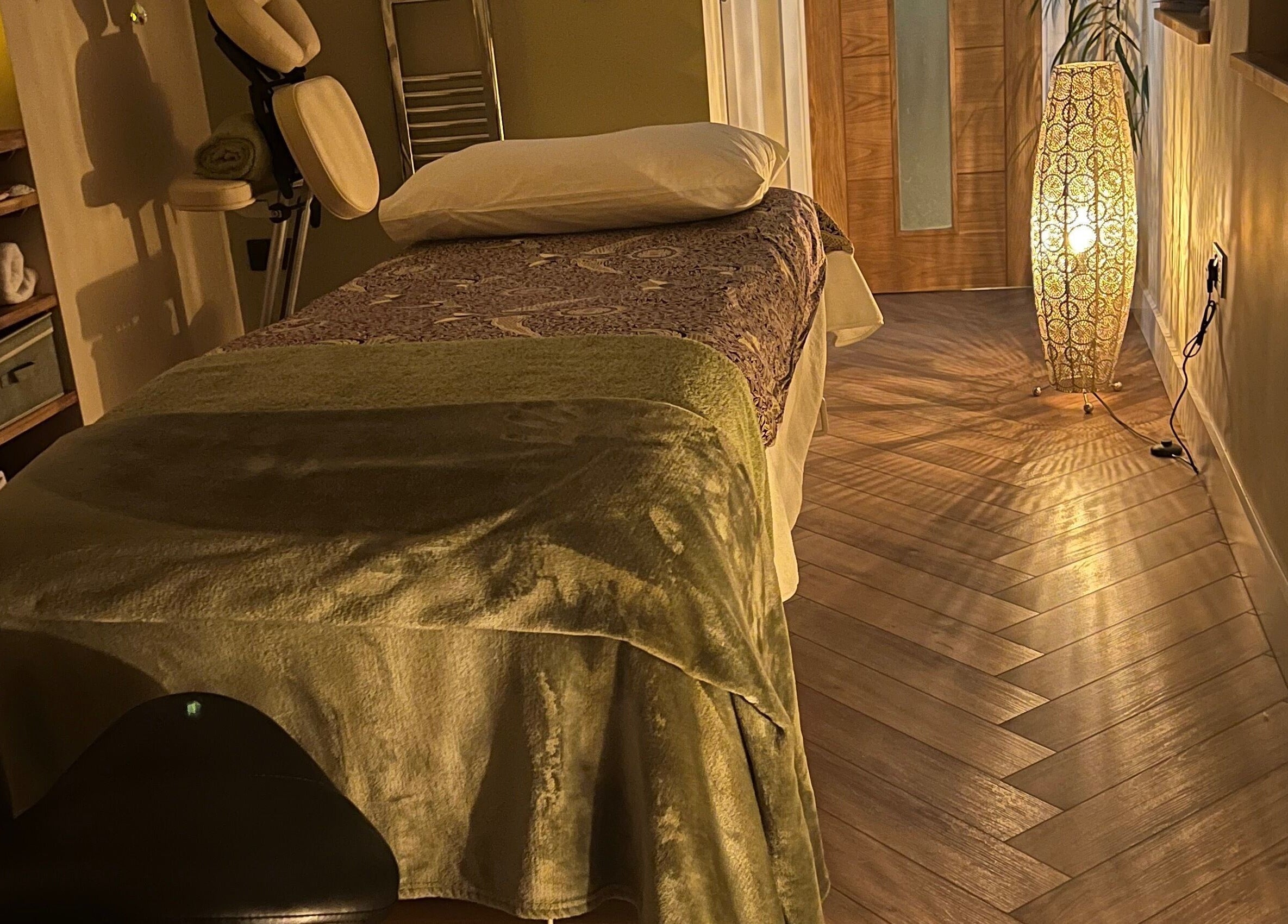 Relaxing massage room at Humblebee Wellness, Saint Leonards, England, GB with soft lighting and a treatment bed.