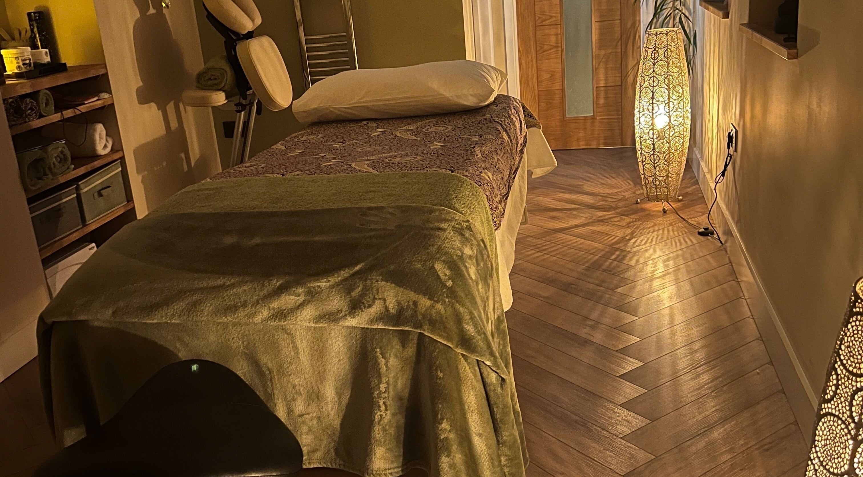 Relaxing massage room at Humblebee Wellness, Saint Leonards, England, GB with soft lighting and a treatment bed.