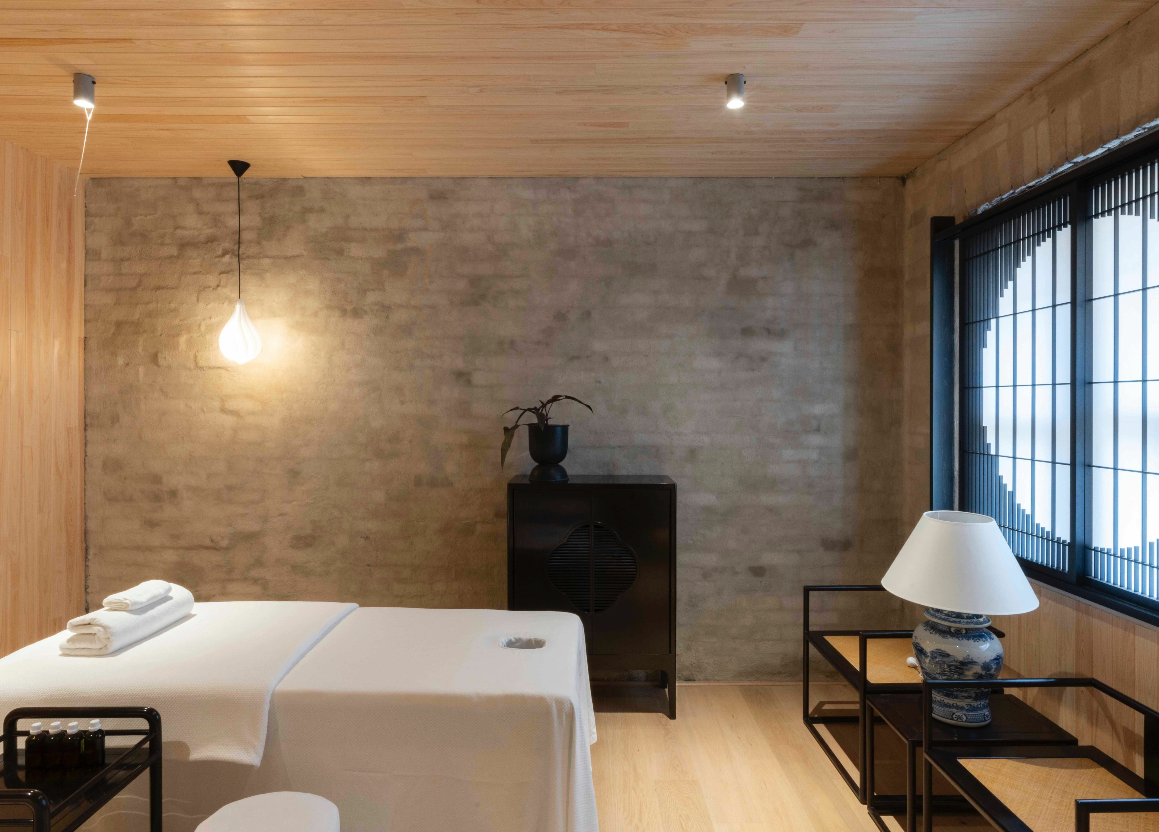 Relaxing massage room at In the Brick Spa, Melbourne, Victoria, AU with soft lighting and modern decor.