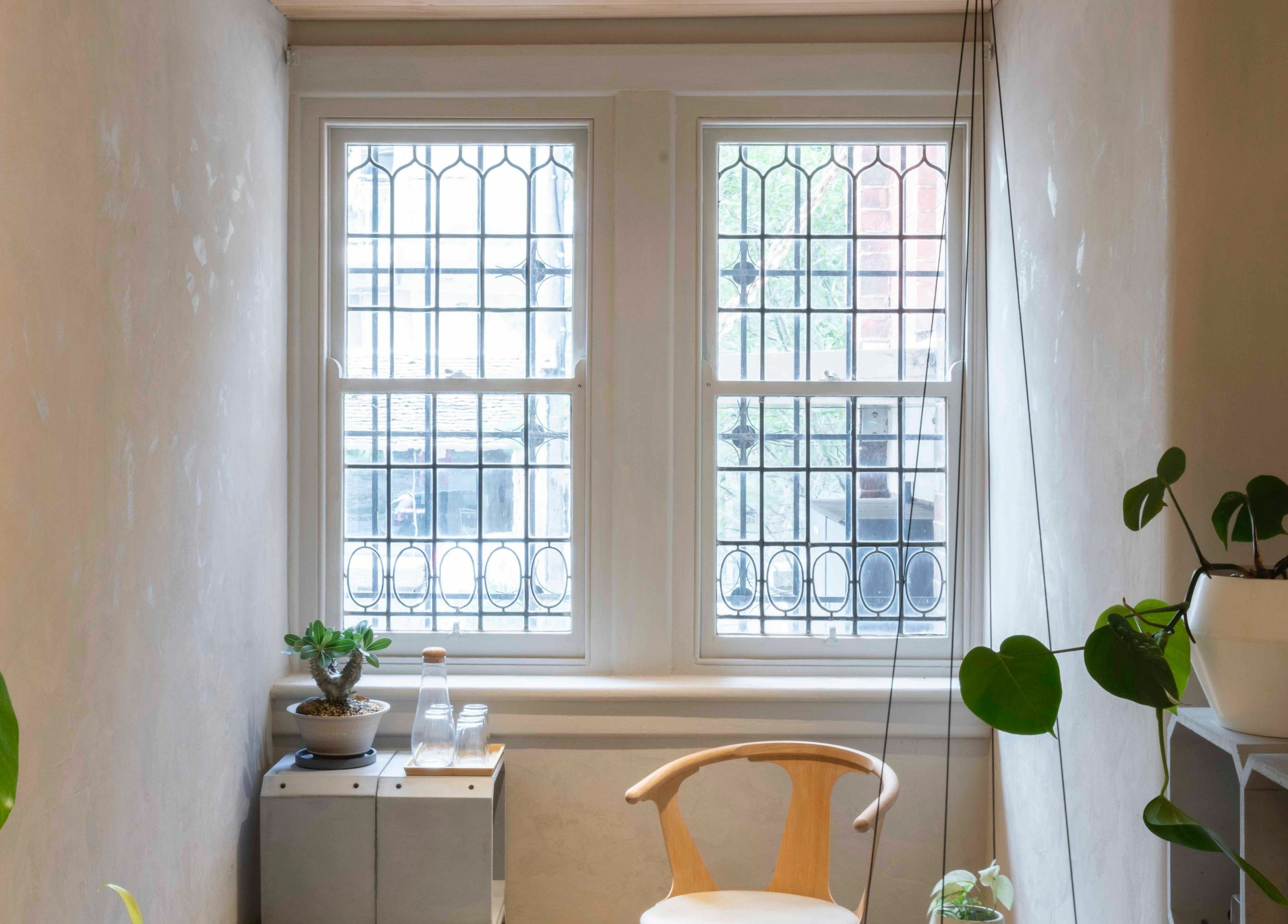 Bright window with plants at In the Brick Spa, Melbourne, Victoria, AU offers a peaceful ambiance.