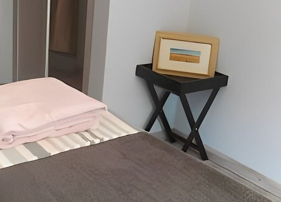 Inviting treatment room at Beauty By Raquel, Randburg, South Africa, ZA with a neatly made bed and decor.