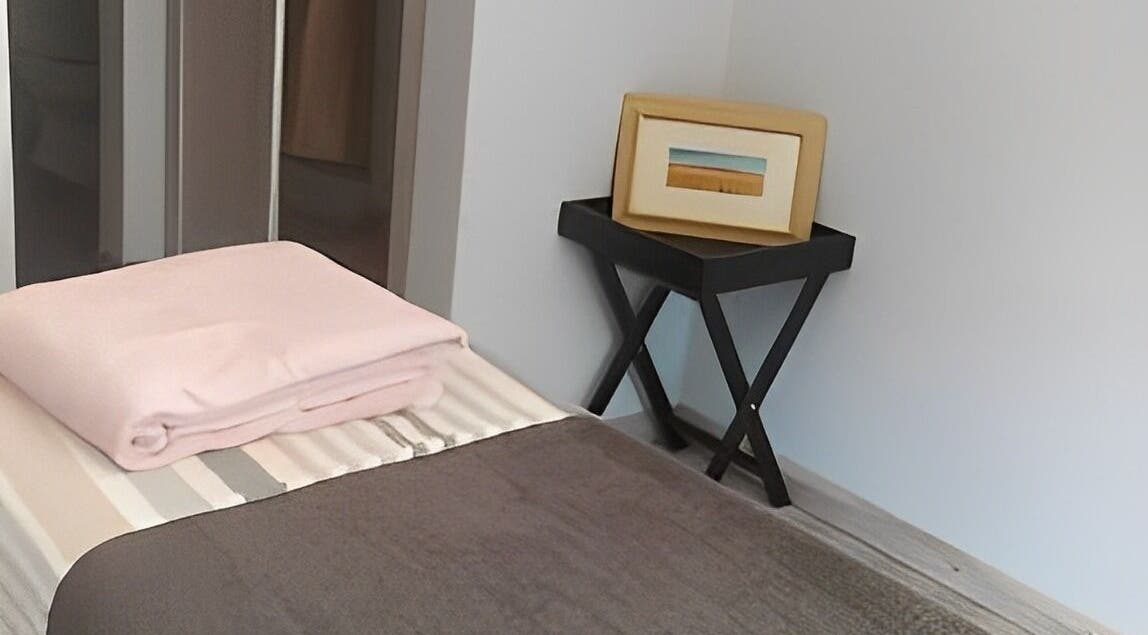 Inviting treatment room at Beauty By Raquel, Randburg, South Africa, ZA with a neatly made bed and decor.