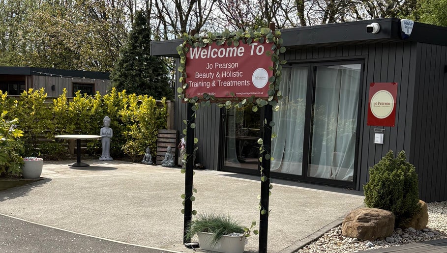Entrance to Jo Pearson Training & Treatments at Carr Gate, England, GB with a welcoming sign and tranquil garden.