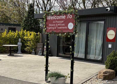 Entrance to Jo Pearson Training & Treatments at Carr Gate, England, GB with a welcoming sign and tranquil garden.