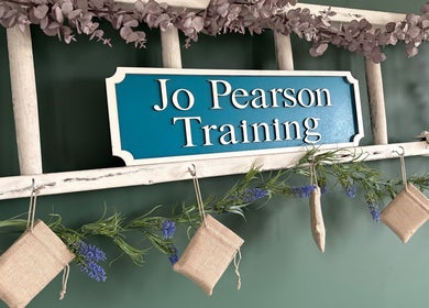 "Jo Pearson Training" sign with floral decor at Carr Gate, England, GB venue.