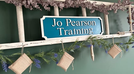 "Jo Pearson Training" sign with floral decor at Carr Gate, England, GB venue.