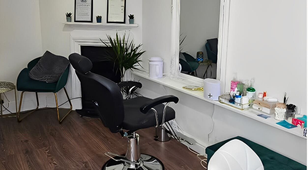 Modern salon chair and mirror at Hannah's Be You Beauty, Norwich, England, GB. Cozy and stylish interior.