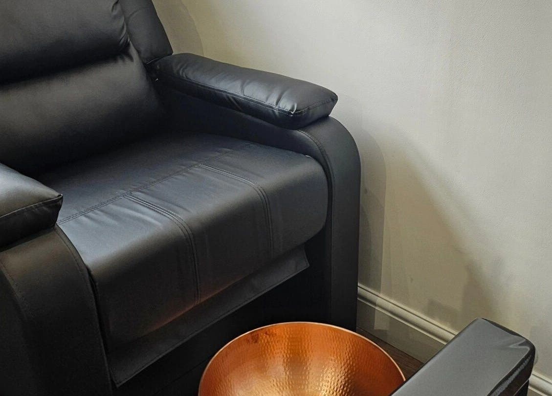 Luxurious pedicure chair at Hannah's Be You Beauty, Norwich, England, GB, featuring sleek black leather finish.