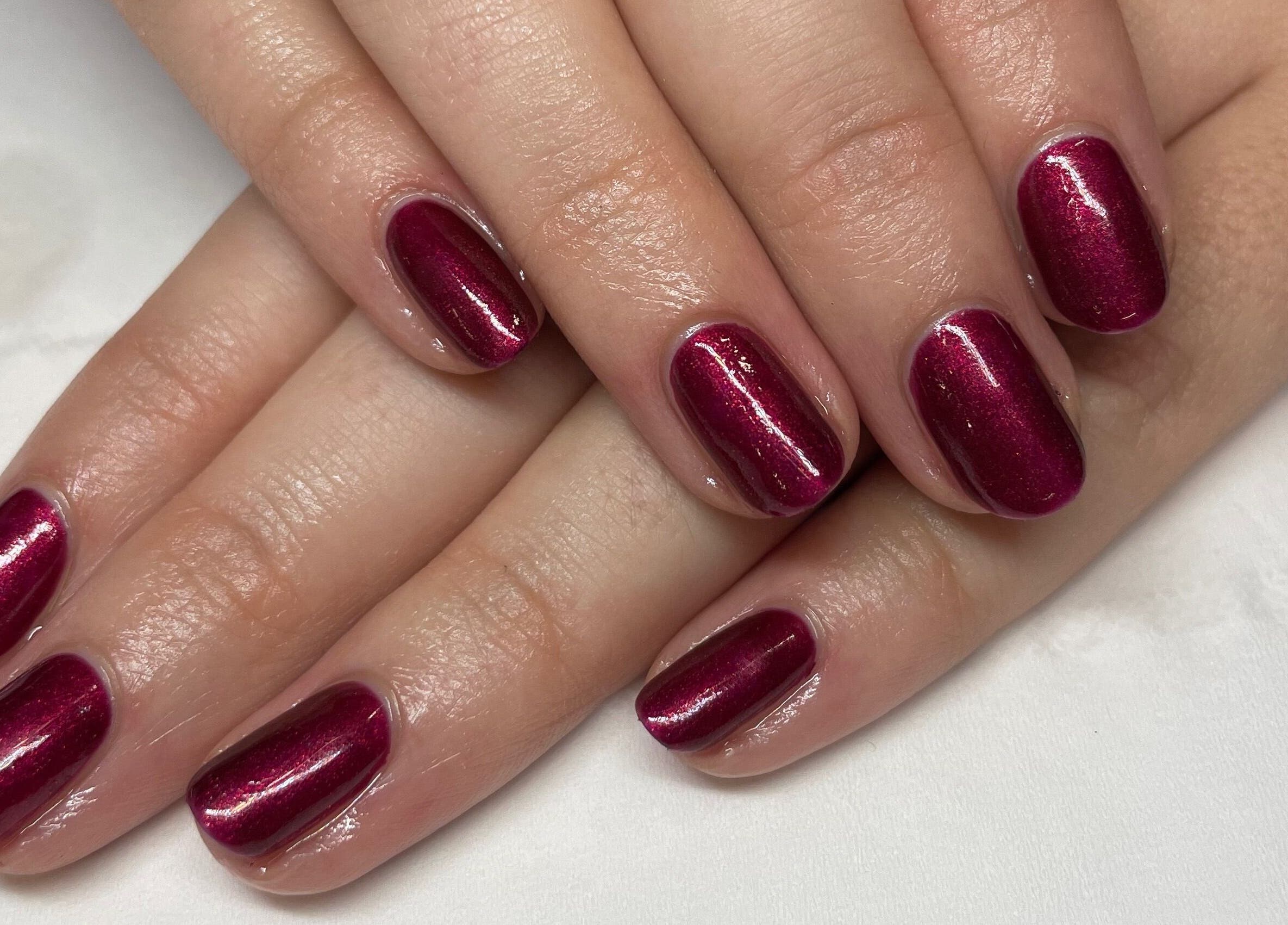 Crimson manicured nails at Hannah's Be You Beauty in Norwich, England, GB. Exquisite nail services displayed.