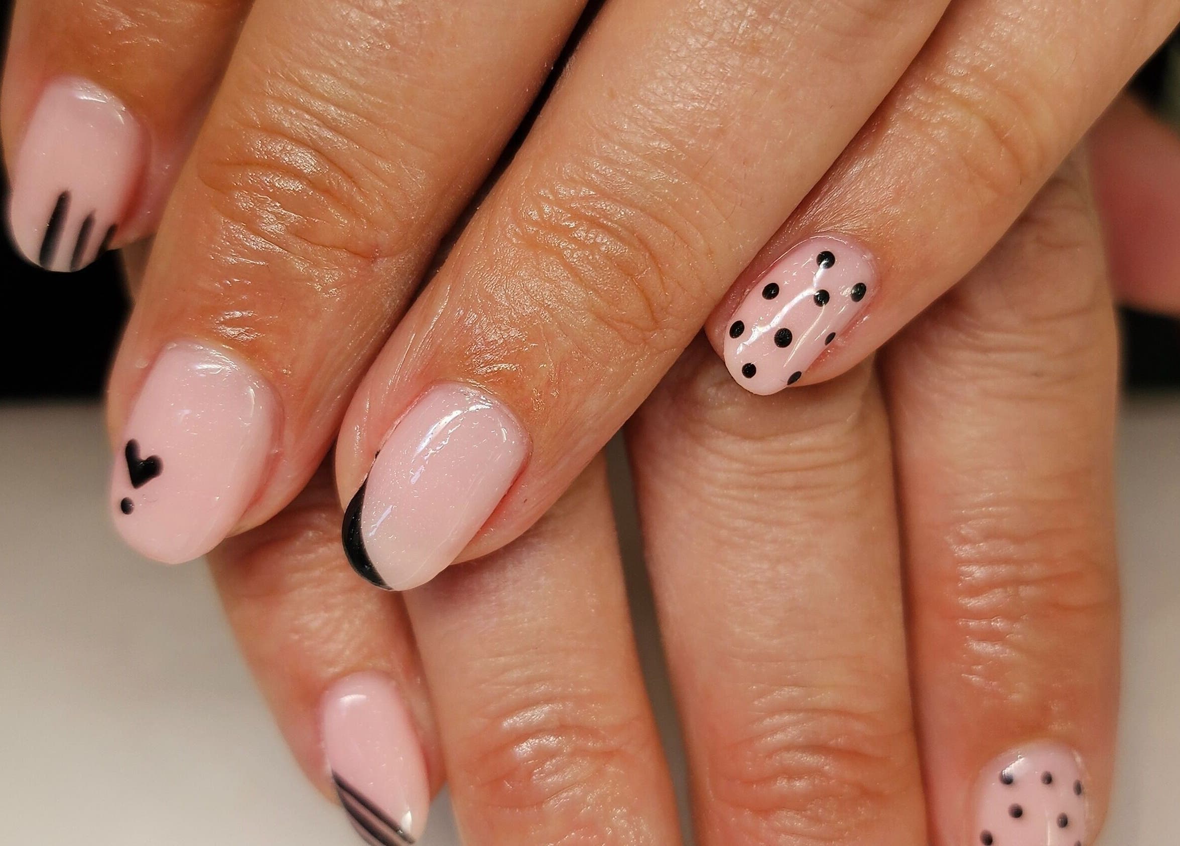 Elegant nail art with black designs at Hannah's Be You Beauty in Norwich, England, GB.