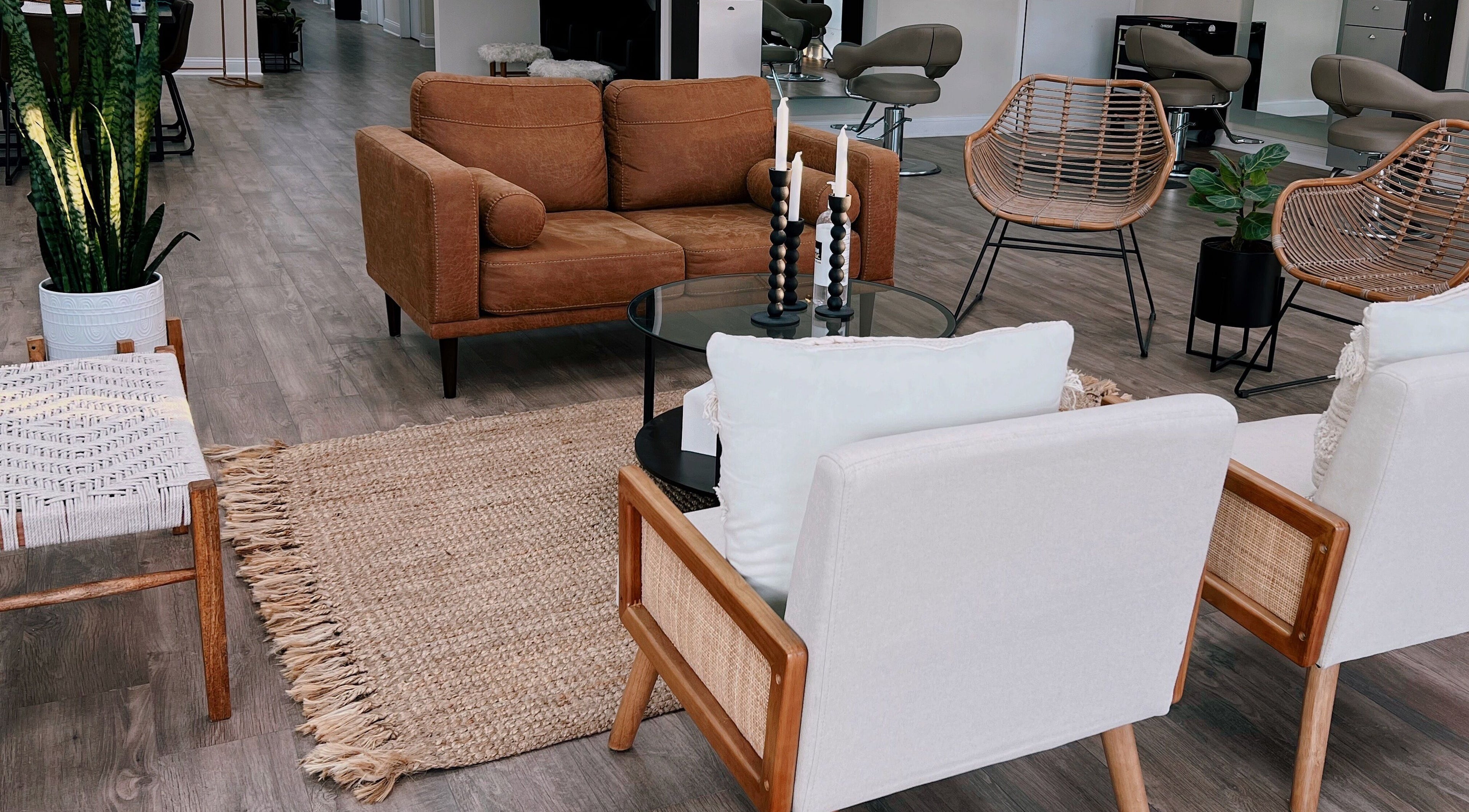 Chic and inviting seating area at Hair By Mia, Mokena, Illinois, US, featuring modern chairs and lush greenery.
