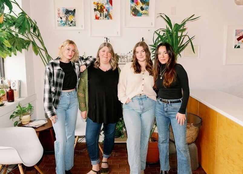 Team at Lavender beauty venue in Portland, Maine, US, showcasing a bright, welcoming space with green plants.