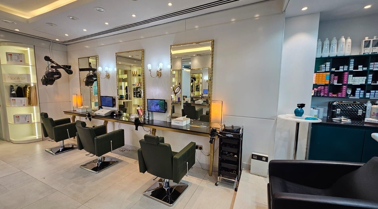 Chic styling area at Osama Kasir Beauty Salon and Barbershop in Dubai, AE with modern chairs and mirrors.