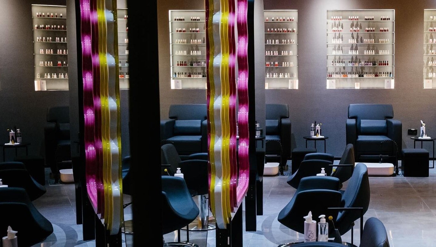 Elegant seating area at 360 Beauty Lounge in Sharjah, Sharjah, AE with modern decor and nail polish display.