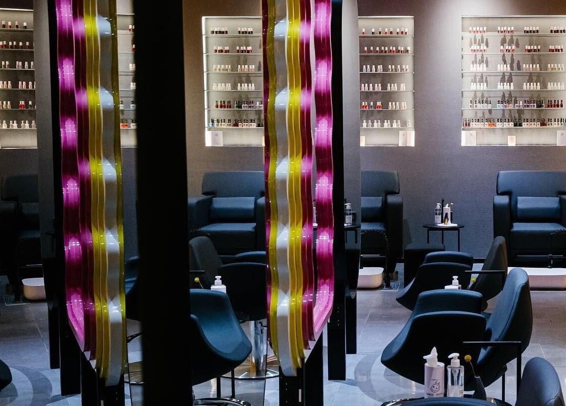 Elegant seating area at 360 Beauty Lounge in Sharjah, Sharjah, AE with modern decor and nail polish display.