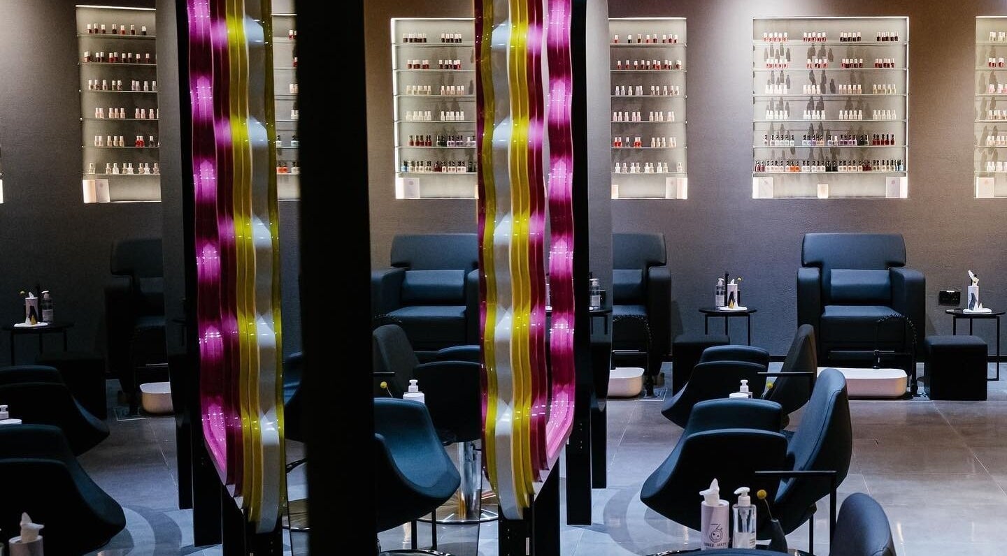 Elegant seating area at 360 Beauty Lounge in Sharjah, Sharjah, AE with modern decor and nail polish display.