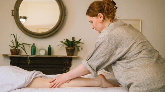 Therapist performing leg massage at Ruby's Refuge at The Calstock Therapy Hub, Calstock, England, GB.