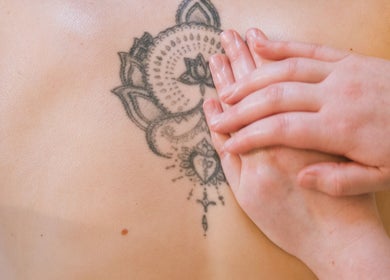 Therapist massaging back tattoo at Ruby's Refuge at The Calstock Therapy Hub (Thursday), Calstock, England, GB.