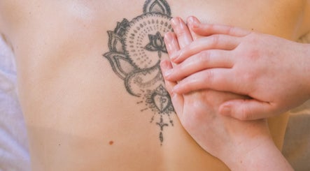 Therapist massaging back tattoo at Ruby's Refuge at The Calstock Therapy Hub (Thursday), Calstock, England, GB.