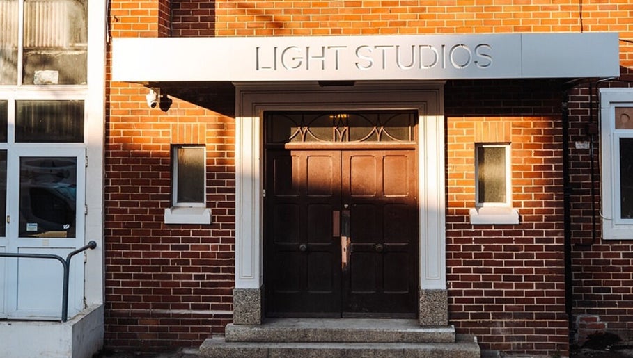 Front entrance of Ruby's Refuge at Light Studios, Plymouth, England, GB, showcasing a sleek modern design.