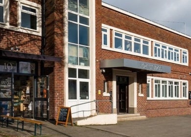 Exterior of Ruby's Refuge at Light Studios in Plymouth, England, showcasing its welcoming brick facade.