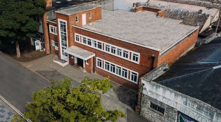 Ruby's Refuge at Light Studios, red brick building in Plymouth, England, GB, aerial view.