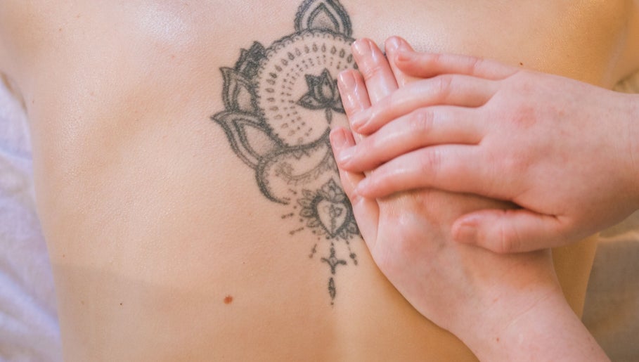 Tattooed back receiving calming massage at Ruby's Refuge at The Calstock Therapy Hub, Calstock, England, GB.