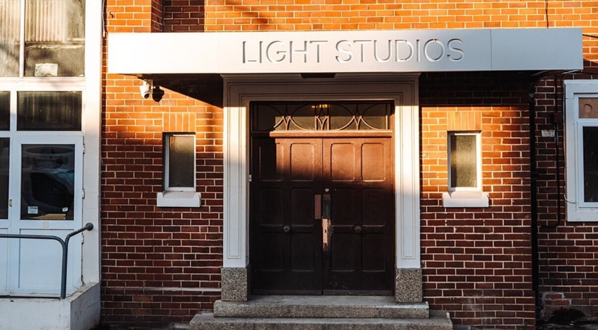 Front entrance of Ruby's Refuge at Light Studios, Plymouth, England, GB, showcasing a stylish brick facade.